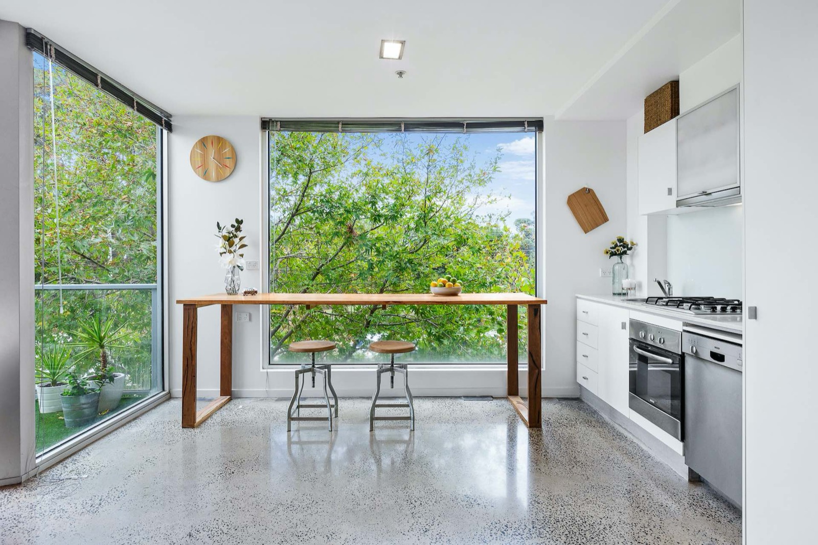 Handcrafted timber high table in a sunlit kitchen